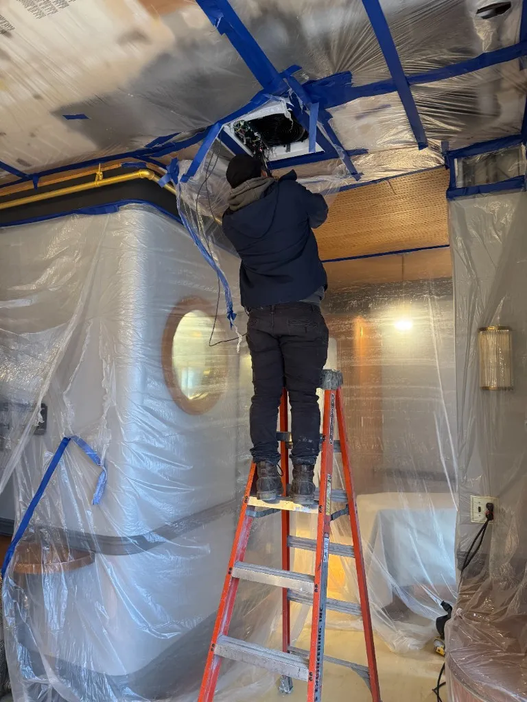 Ceiling cassette VRF indoor unit installation during the Sentinel Building hospitality interior build-out, San Francisco.