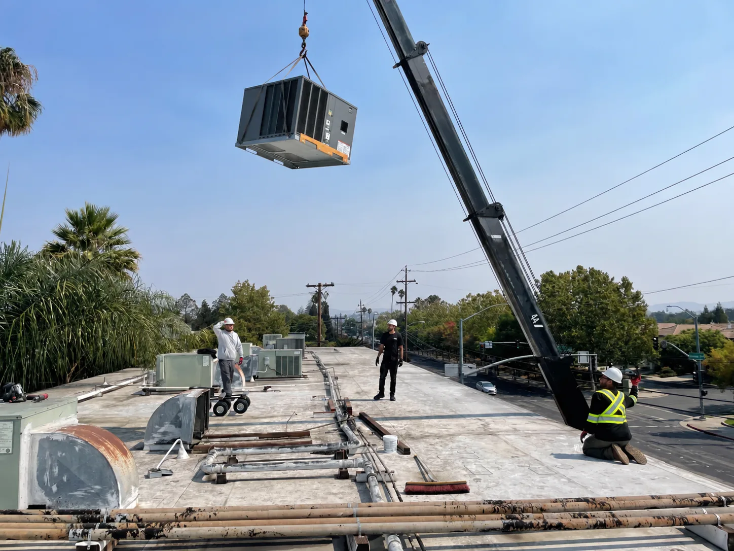 3rdGen technician servicing a Mitsubishi Electric rooftop unit during commercial tenant improvement HVAC work