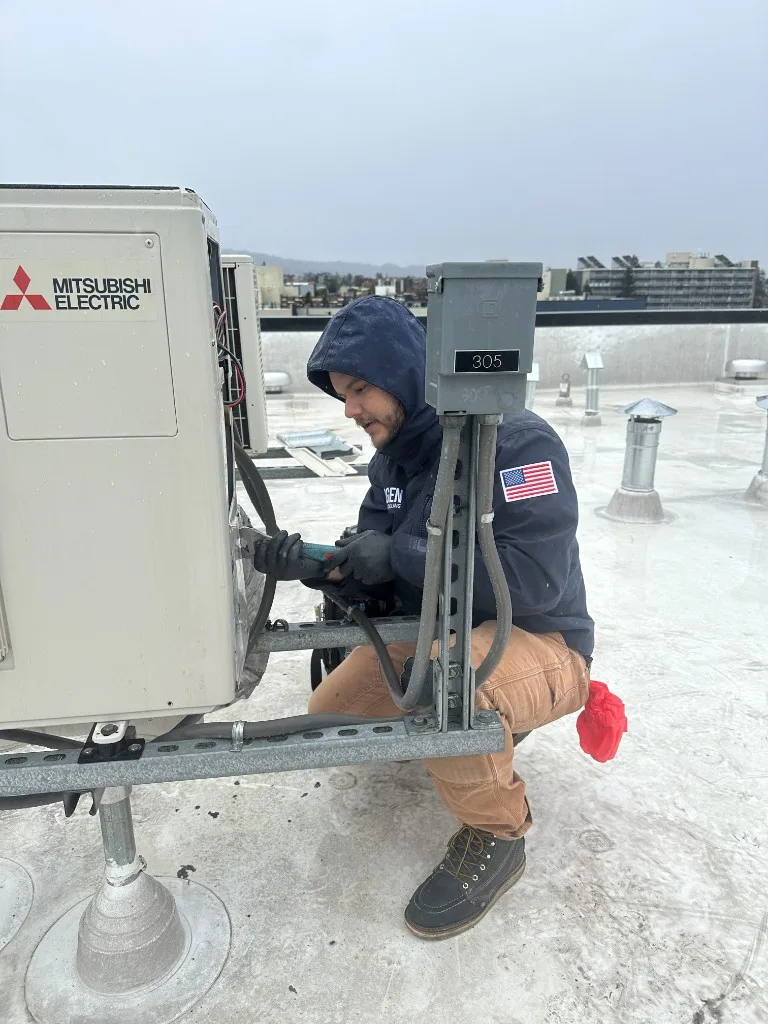 3rdGen technician servicing a Mitsubishi Electric rooftop unit during commercial tenant improvement HVAC work