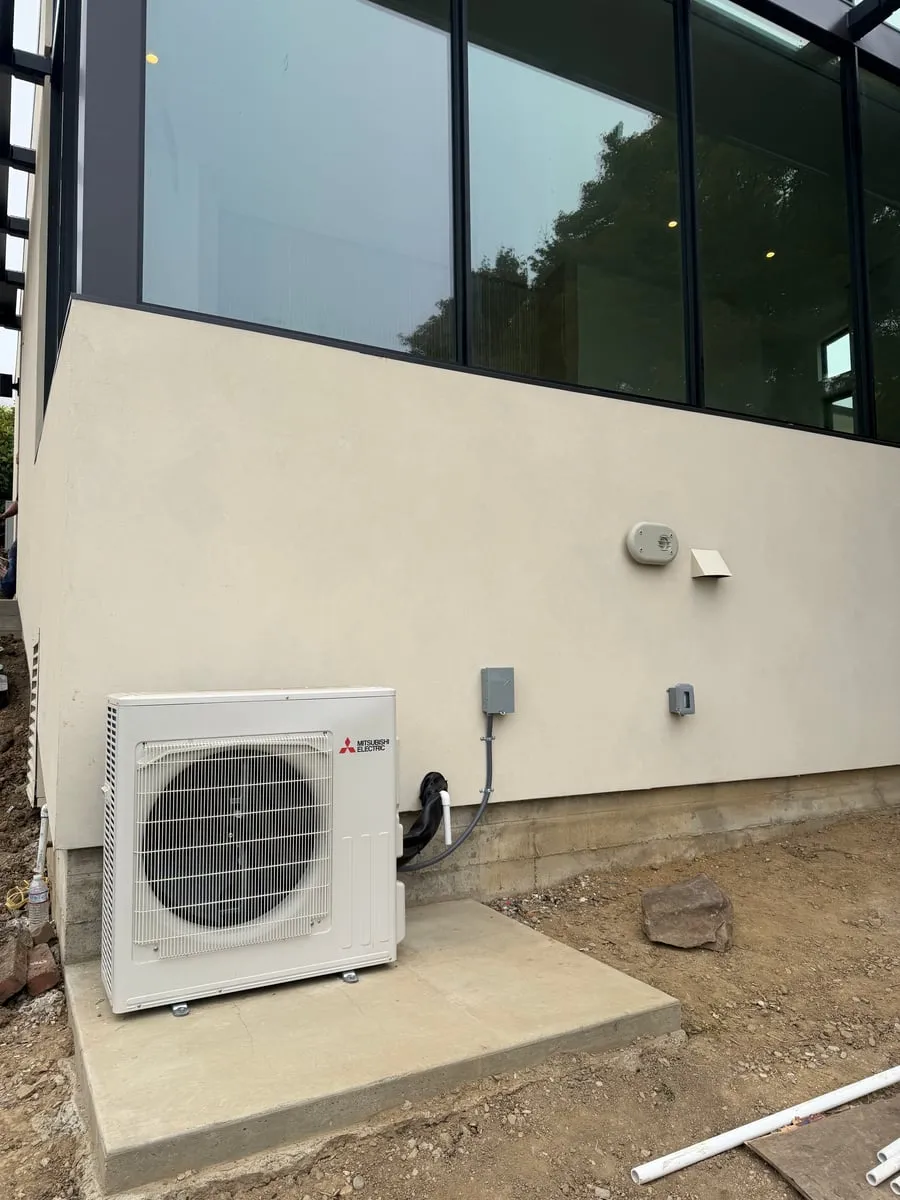 Mitsubishi Electric outdoor heat pump installed on a concrete pad at a Bay Area home