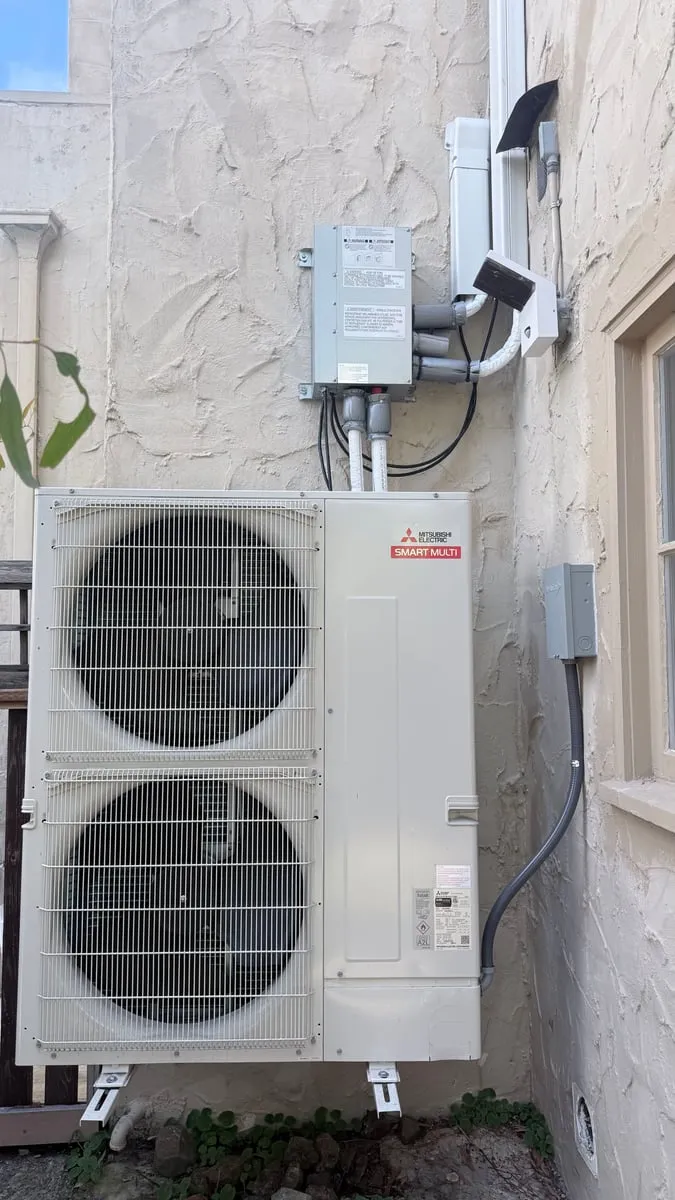 Mitsubishi Electric Smart Multi outdoor unit wall-mounted on a residential exterior